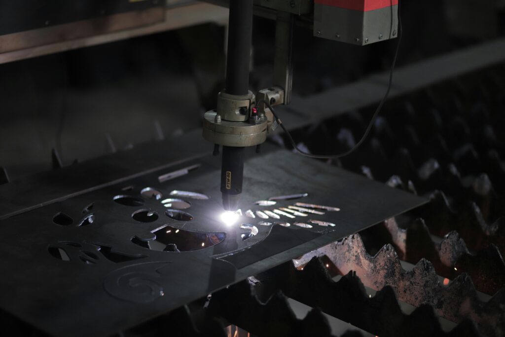 pexels photo 17180807 17180807 Close-up of a plasma cutting machine working on a metal sheet in an industrial setting.
